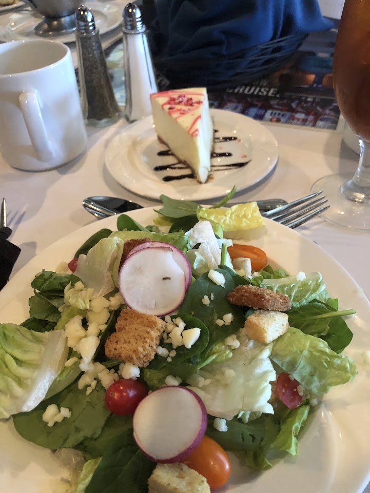 Picture of a salad and slice of cake served on The General Jackson cruise