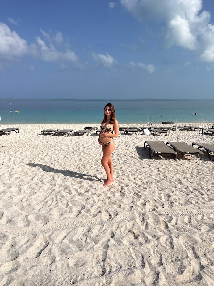 Traveling during the second trimester, which is how pregnant I was in this picture in the Bahamas, is an important pregnancy travel tip.