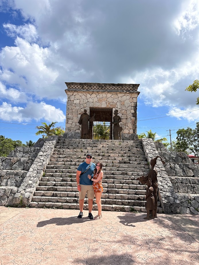 A picture of me and my husband in Mexico while pregnant on our babymoon
