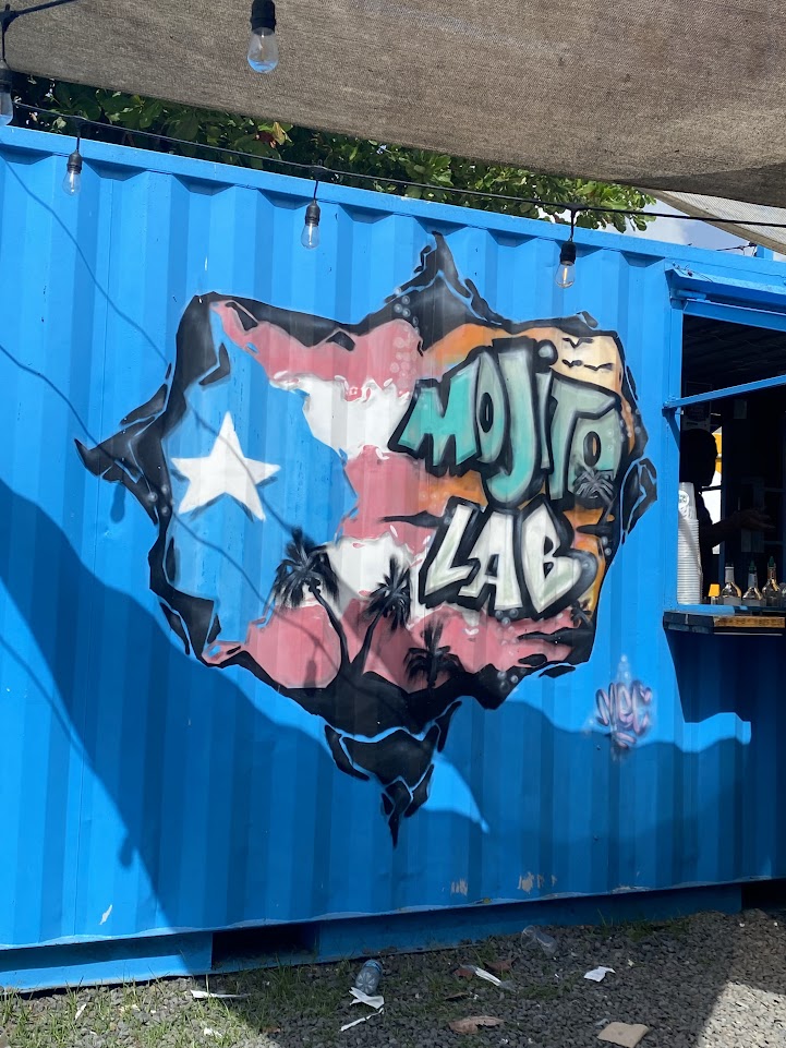 A picture of a mural painted on the side of a bar called "Mojito Lab," which is located on Luquillo beach.